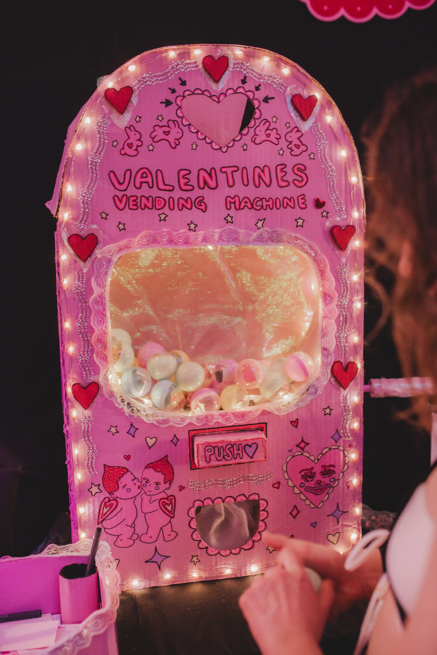 Illuminated pink Valentines Vending Machine artwork at heARTburn 2026
